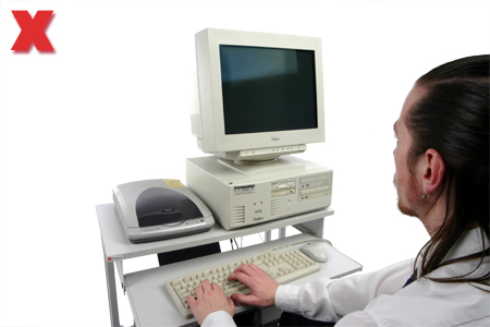 Picture - Typing on an all-in-one computer workstation.