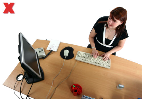 Picture - using a computer with the monitor to one side.