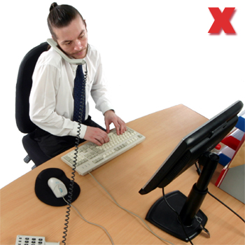 Picture - Cradling the phone with the neck and using the computer.